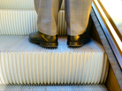 a man's feet on an escalator a man's feet on an escalator